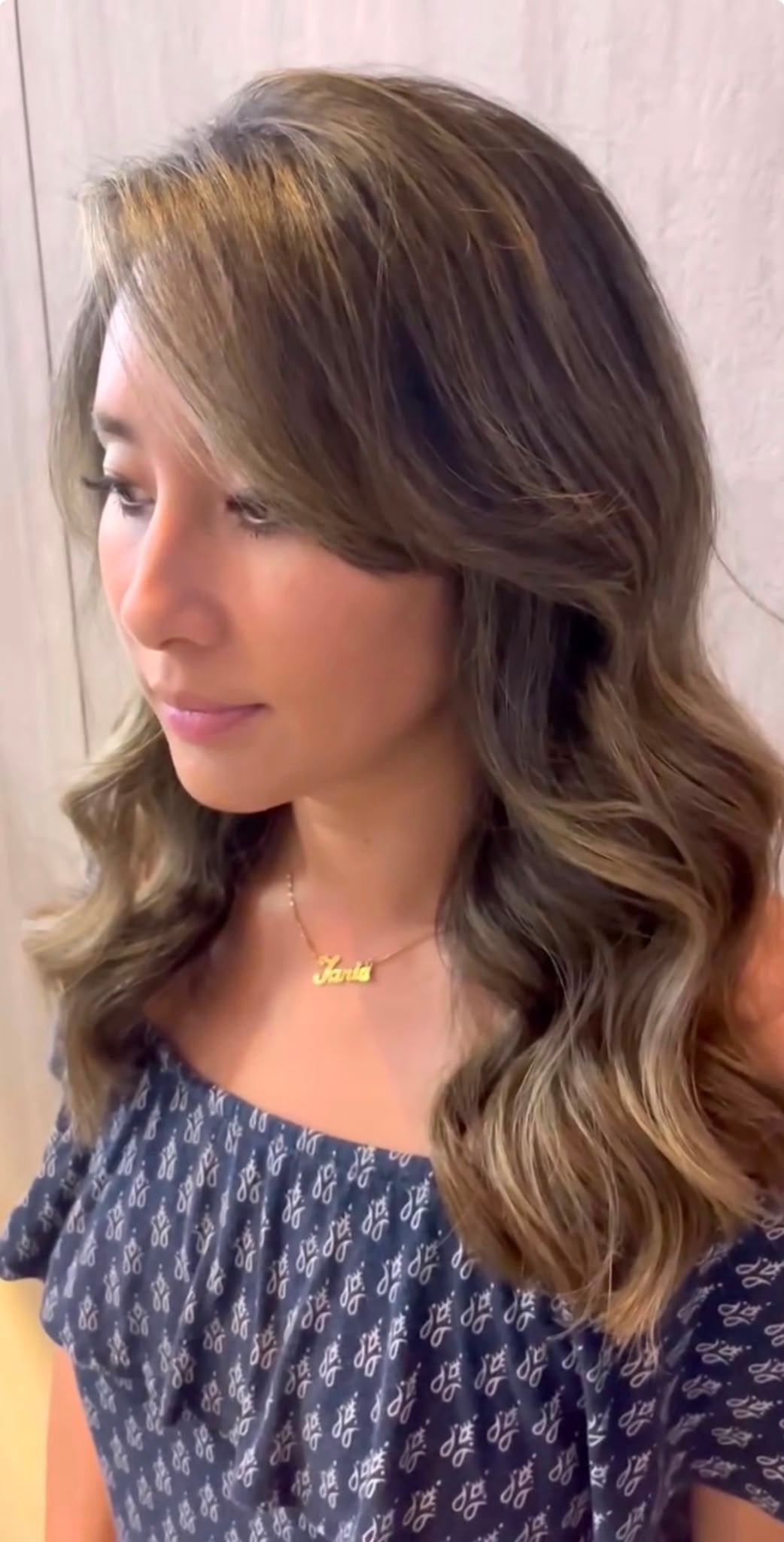 Softly highlighted, waved hair on an Asian client
