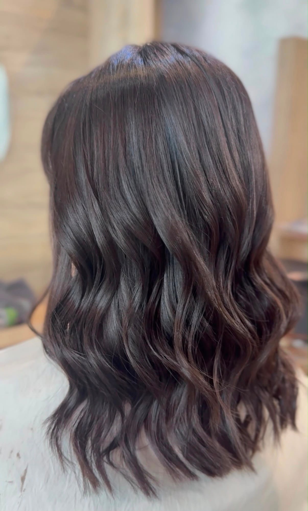 Long dark wavy hair with improved shine and condition after a specialist treatment